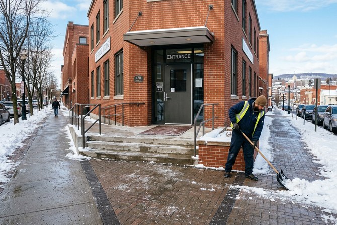 Commercial building entrance cleared of snow with a clear walkway and de-iced steps
